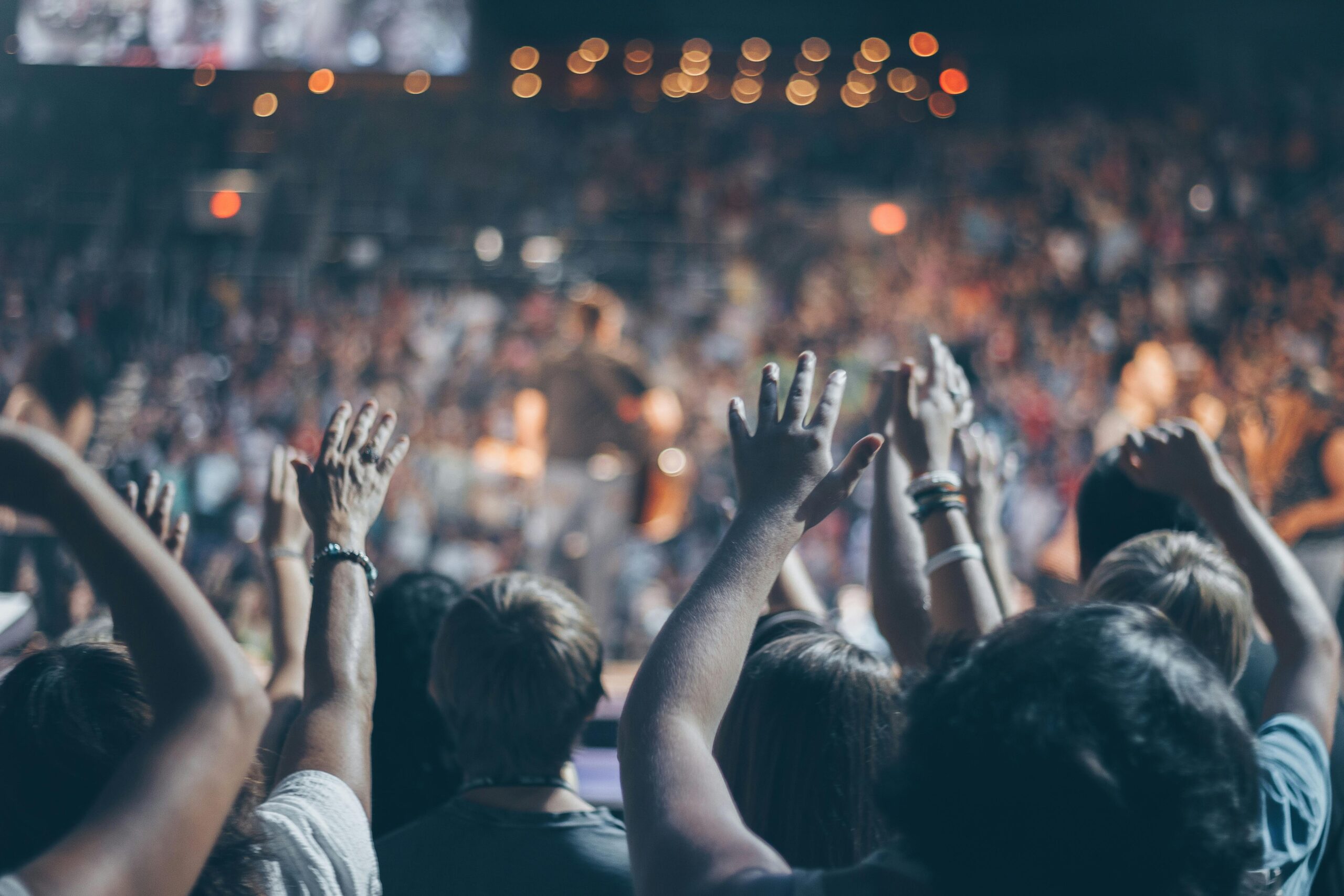 Picture of people with hands raised in worship at church